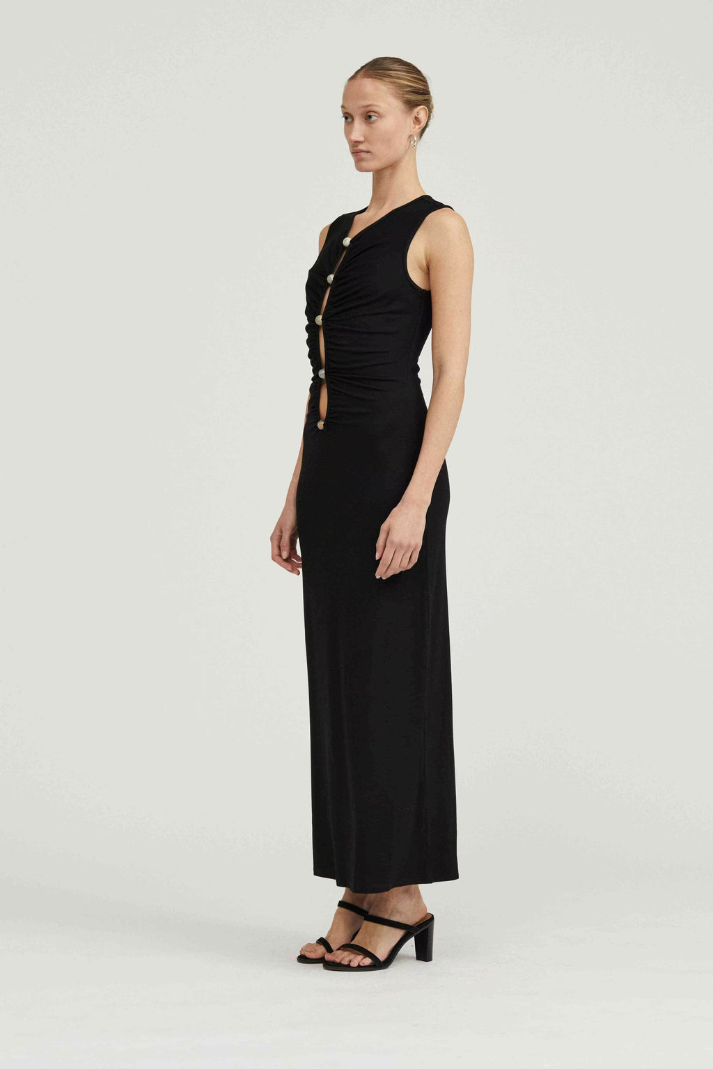 Black sleeveless maxi dress side view with V-neck and button-front detailing