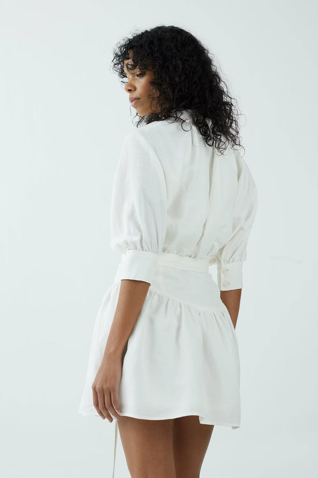 Off-white shirt dress with belted waist and puff sleeves, back/side view