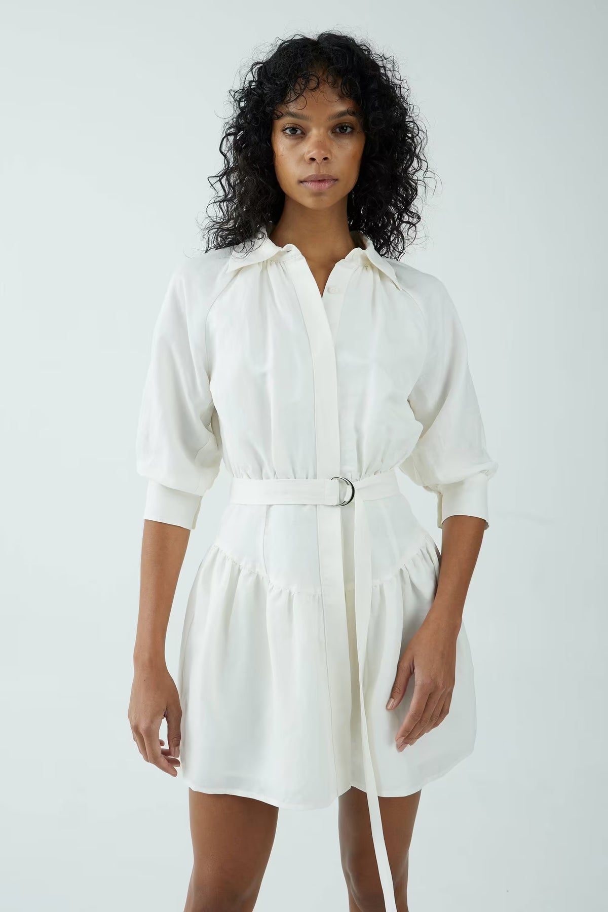 Off-white shirt dress with V-neck collar, puff sleeves, and metal-buckle tie belt