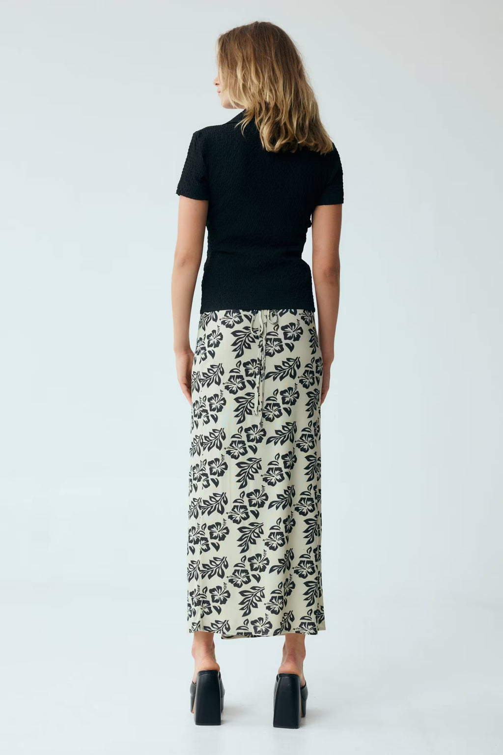 Black waffle texture twist-front V-neck short-sleeve shirt, back view.