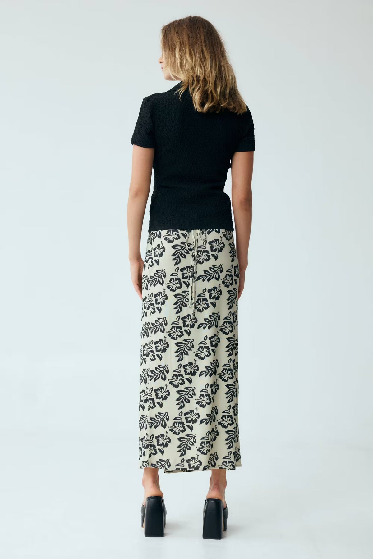 Black waffle texture twist-front V-neck short-sleeve shirt, back view.