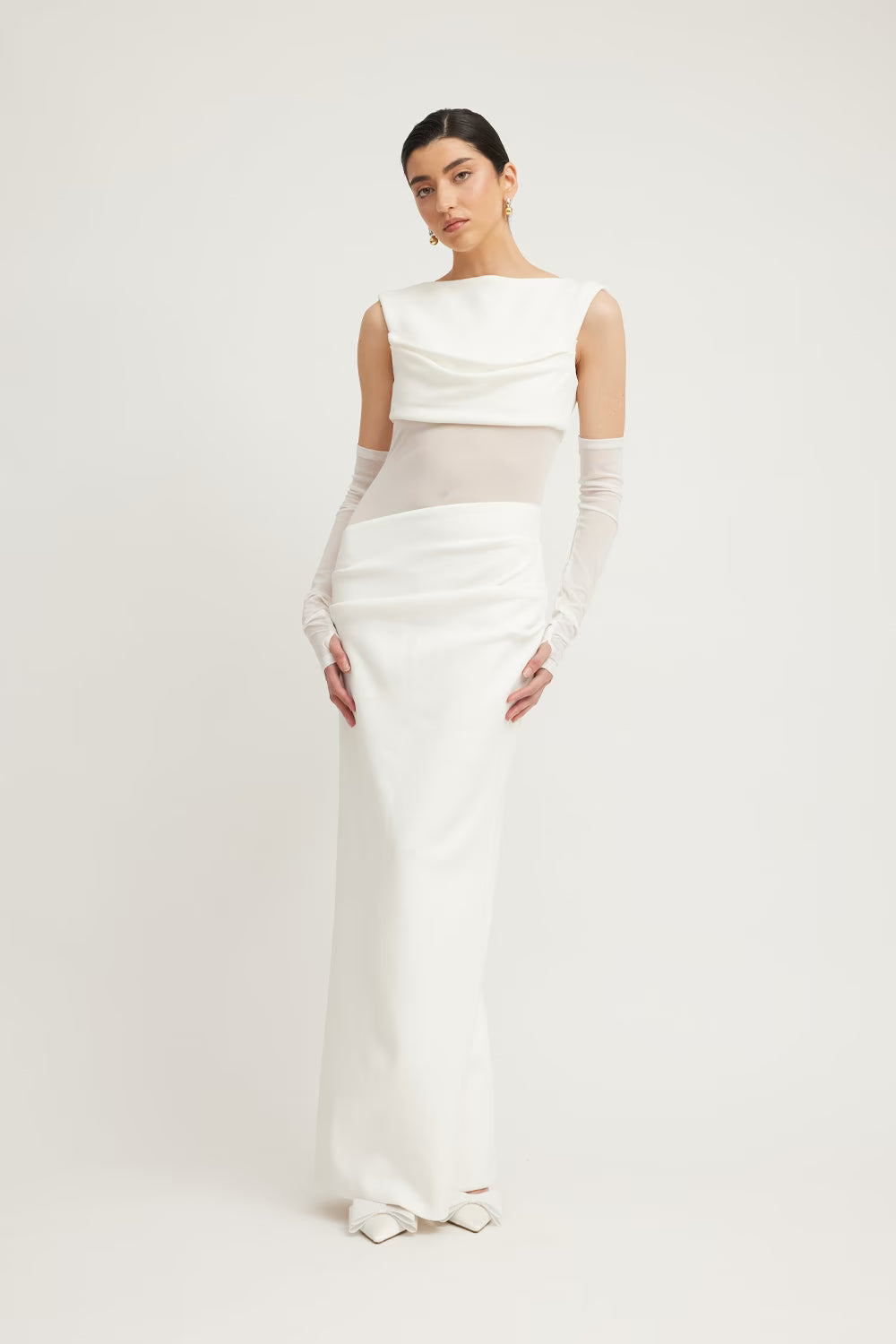 Ivory sleeveless dress with draped neckline, fitted waist, and floor-length hem