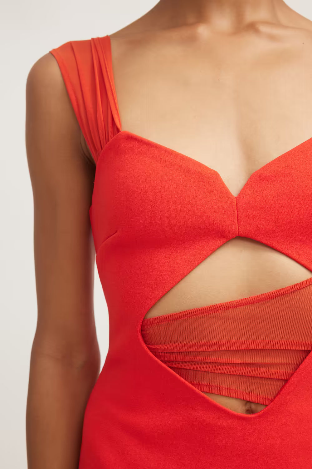 Flame red sleeveless dress close-up: V-neck with overlapping fabric cutout