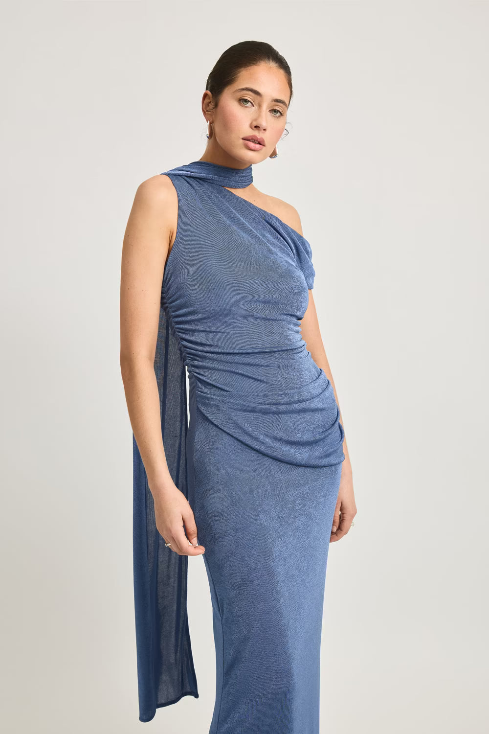 Blue one-shoulder maxi dress with ruched detail and side drape near the hem