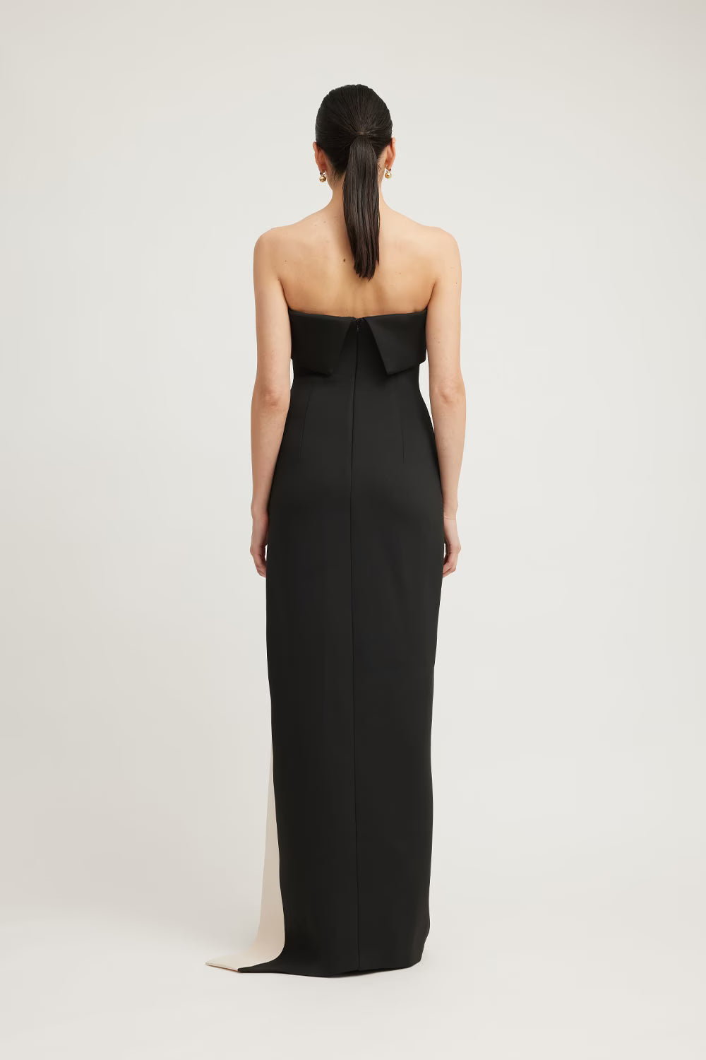 Black strapless column dress with long back slit and champagne contrast panel