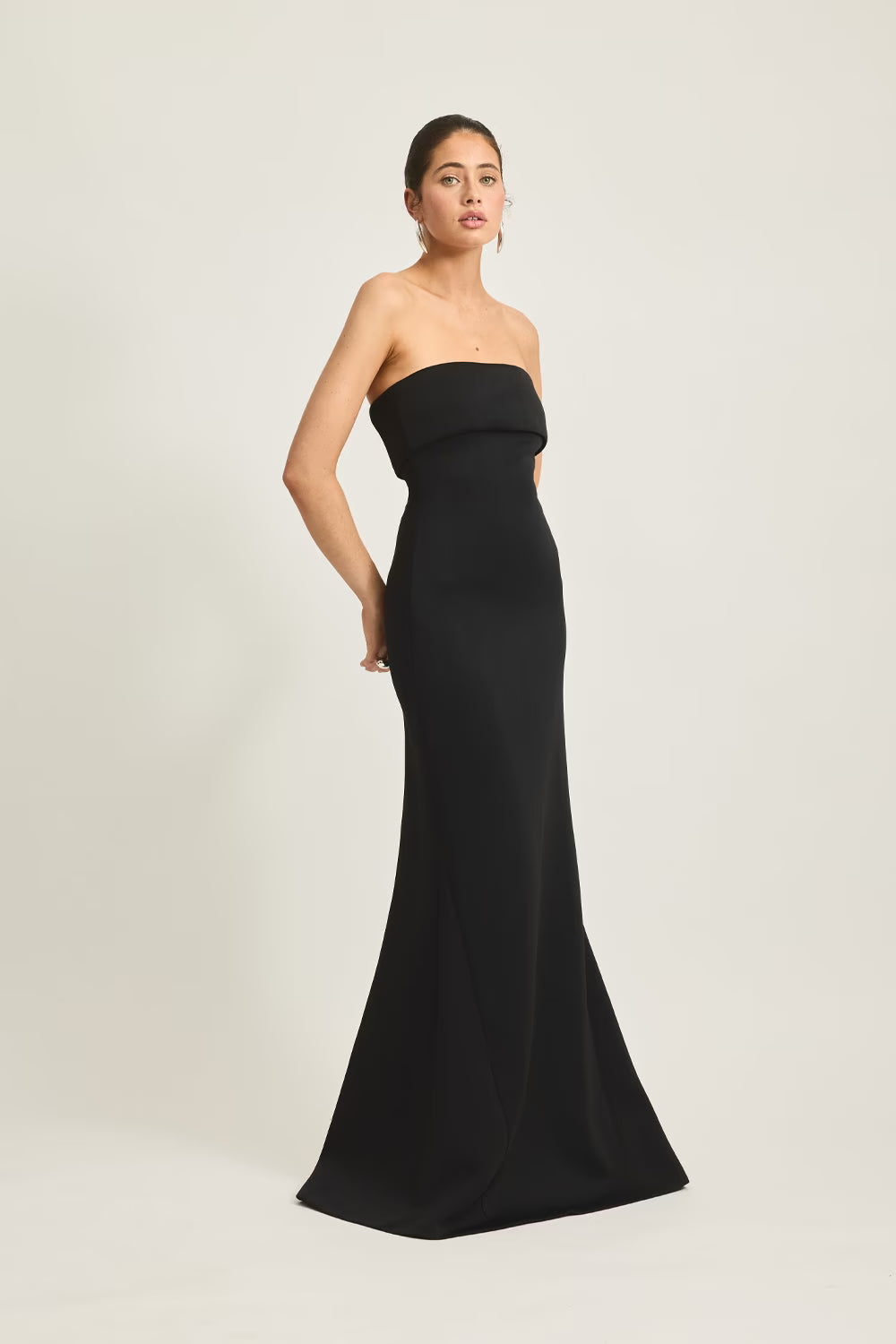 Black strapless evening gown with fitted waist and flared floor-length skirt.
