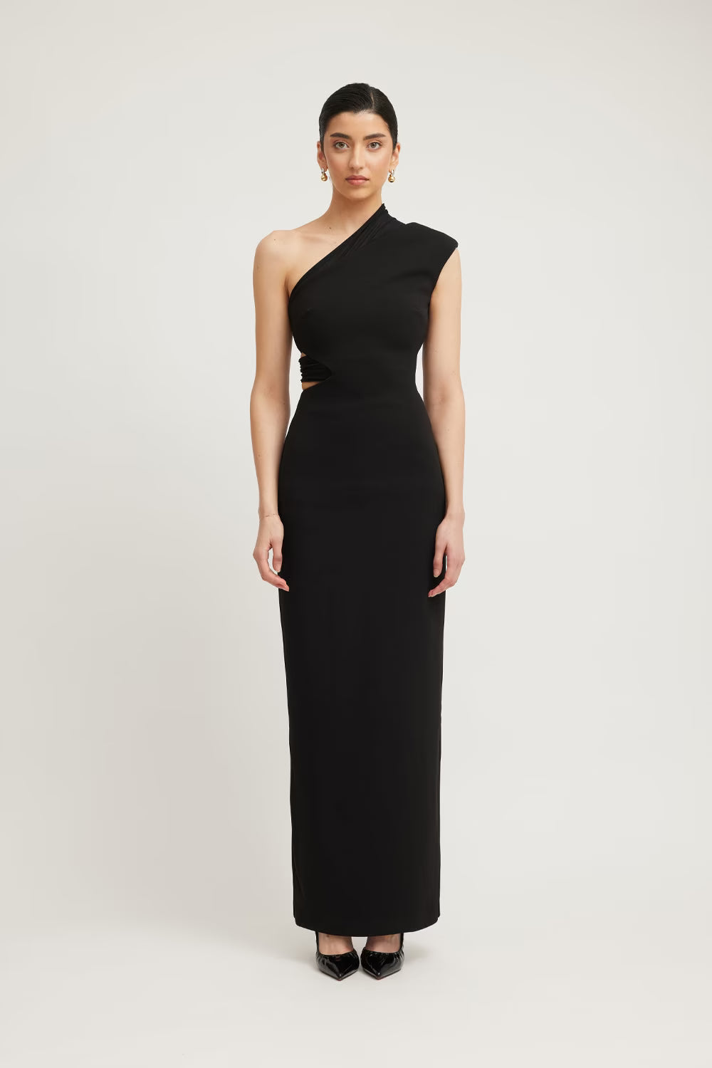 Black sleeveless one-shoulder column dress with side cutout at waist