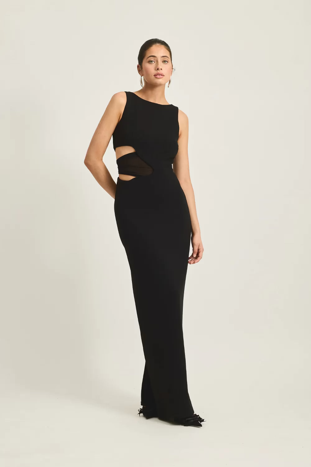 Black sleeveless fitted maxi dress with waist cutout and straight neckline