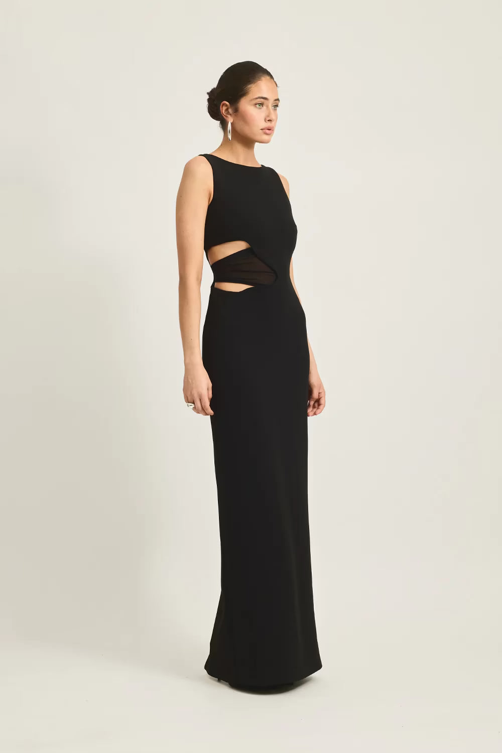 Black sleeveless maxi dress with side waist cutout opening, floor-length fit