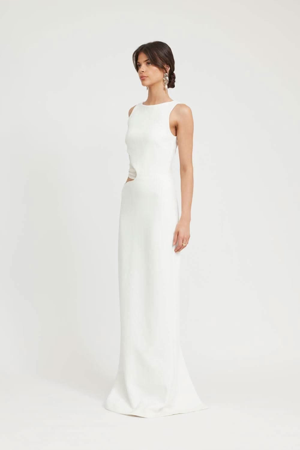 Ivory sleeveless midi dress, side view with asymmetric waist cutout