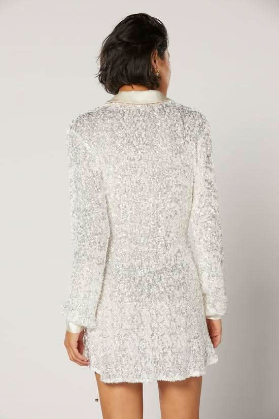 White speckled wrap shirt back view with long sleeves and short hem.