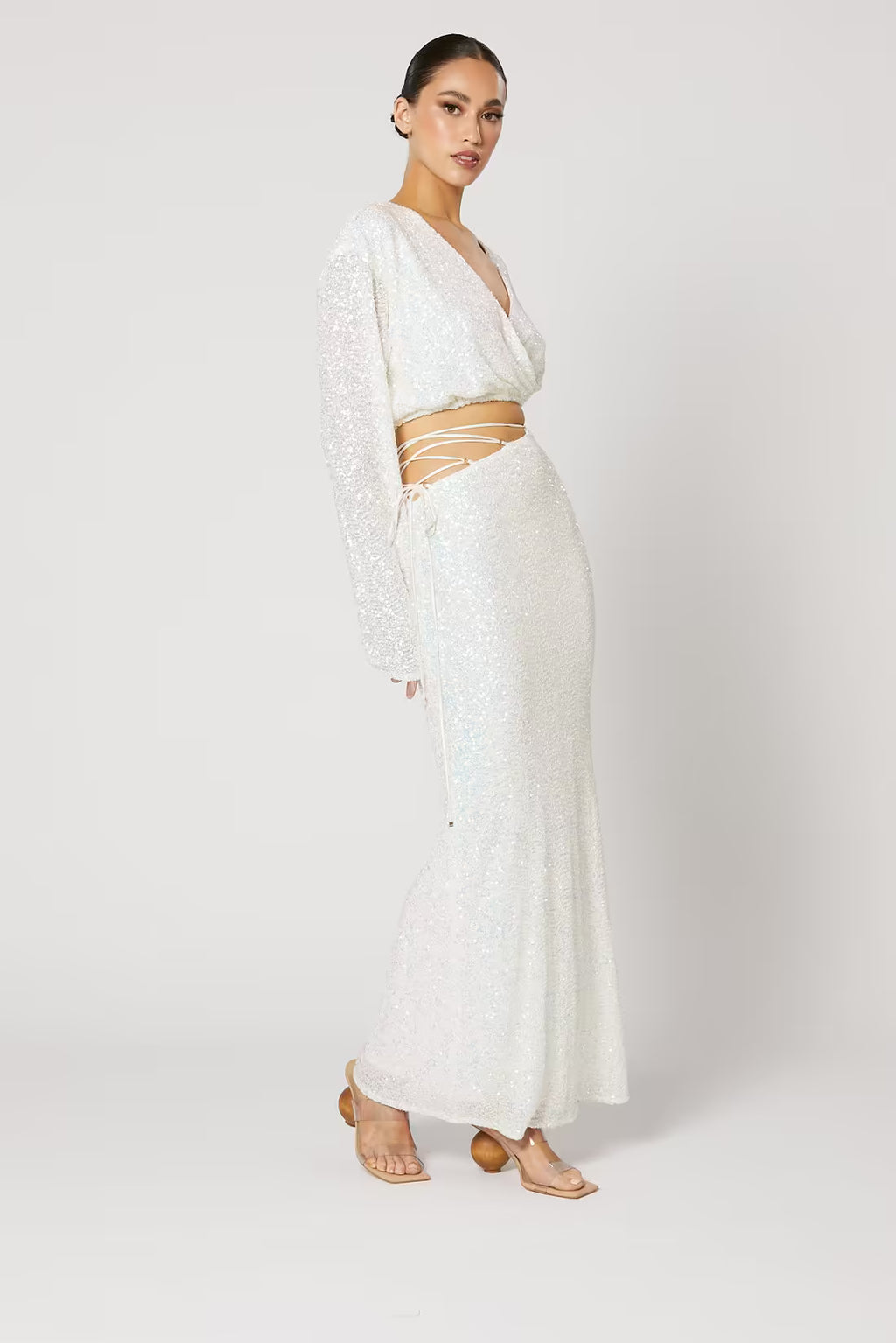 Cristobal sequin maxi skirt in white, side view with fitted waist and flared maxi length