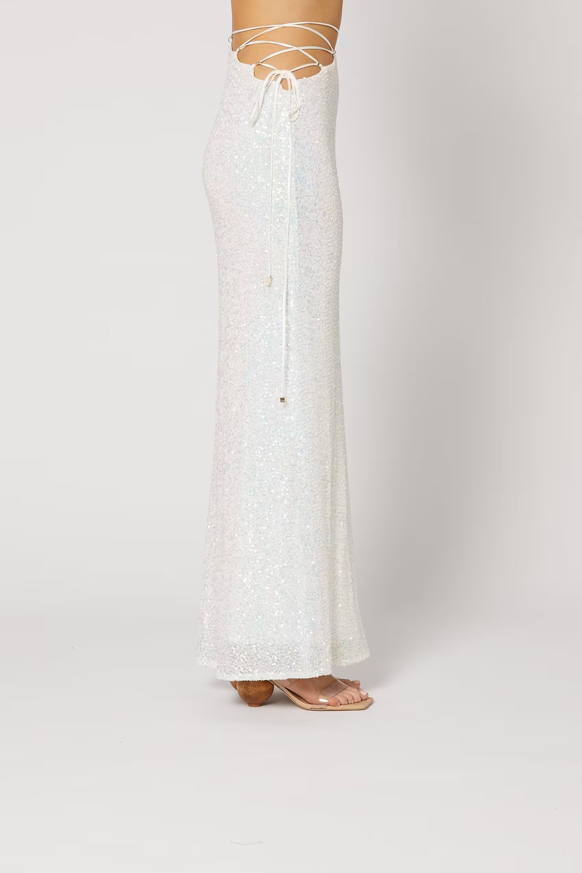 Cristobal sequin maxi skirt in white, angled view with fitted waist and flared hem