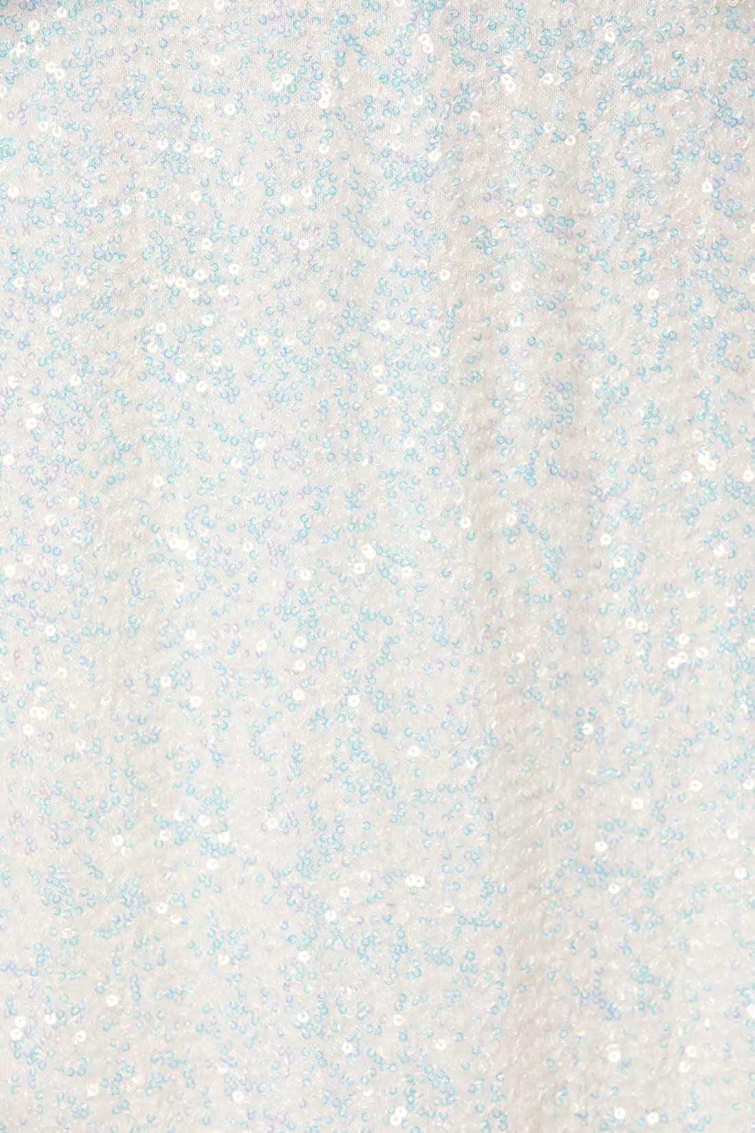 Close-up of light silver-white sequin fabric with small multicolor sparkle flecks