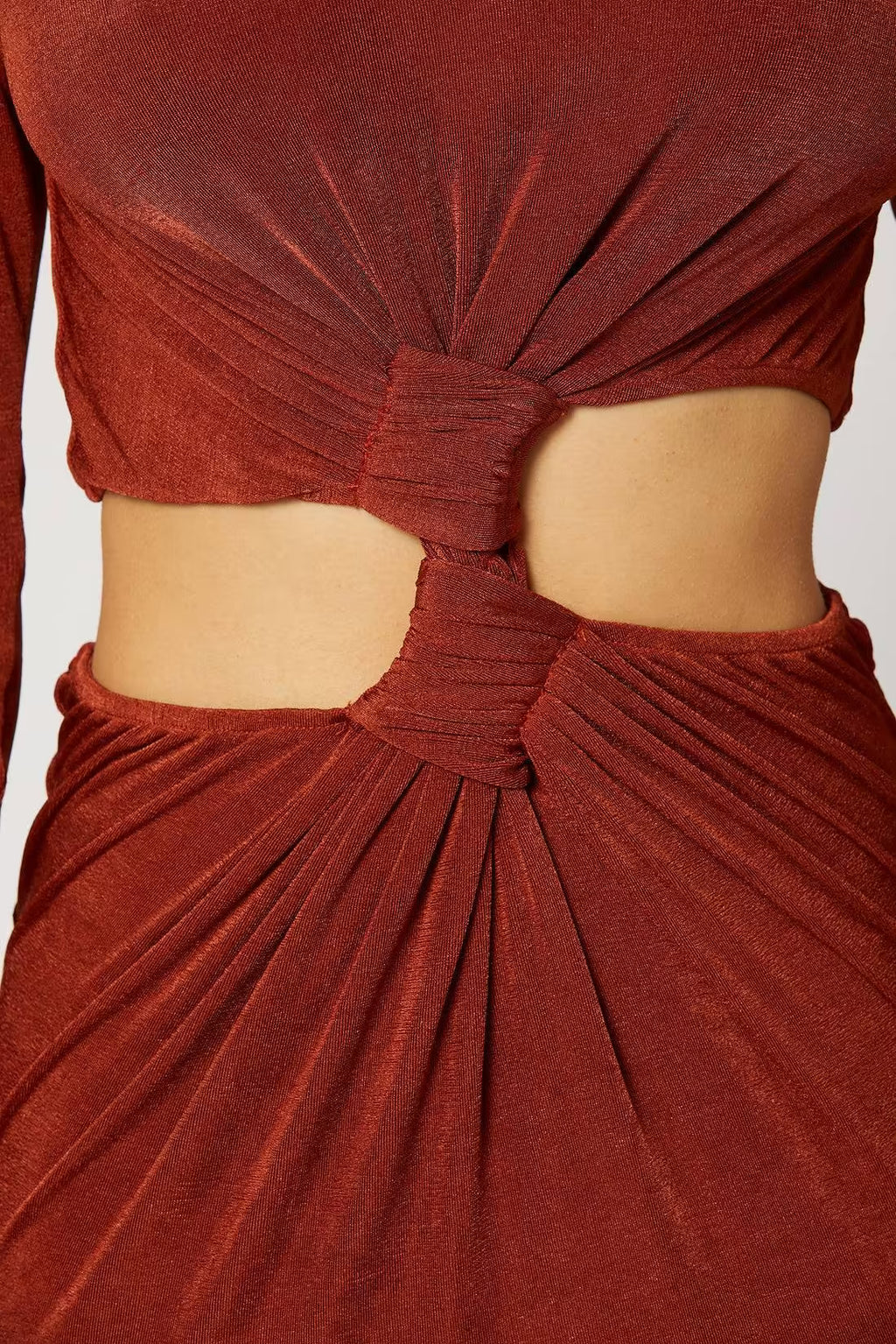 Copper ruched dress fabric close-up with gathered knot at the waist