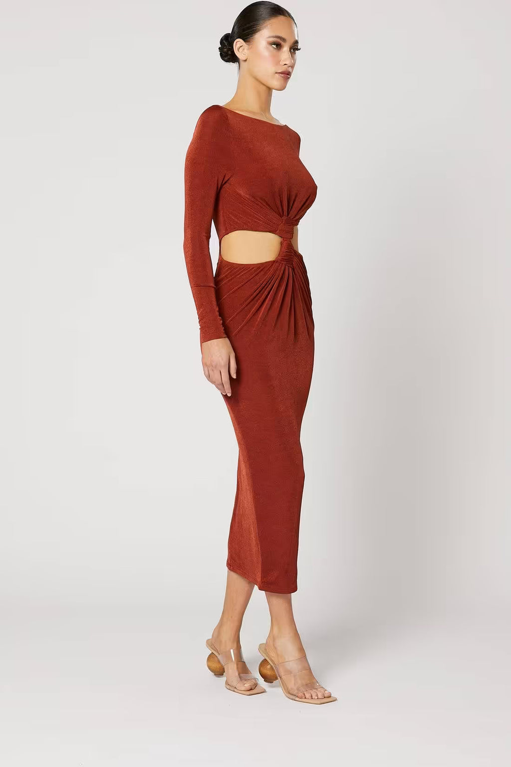 Copper ruched midi dress with long sleeves and knot waist, side view with midriff cutout