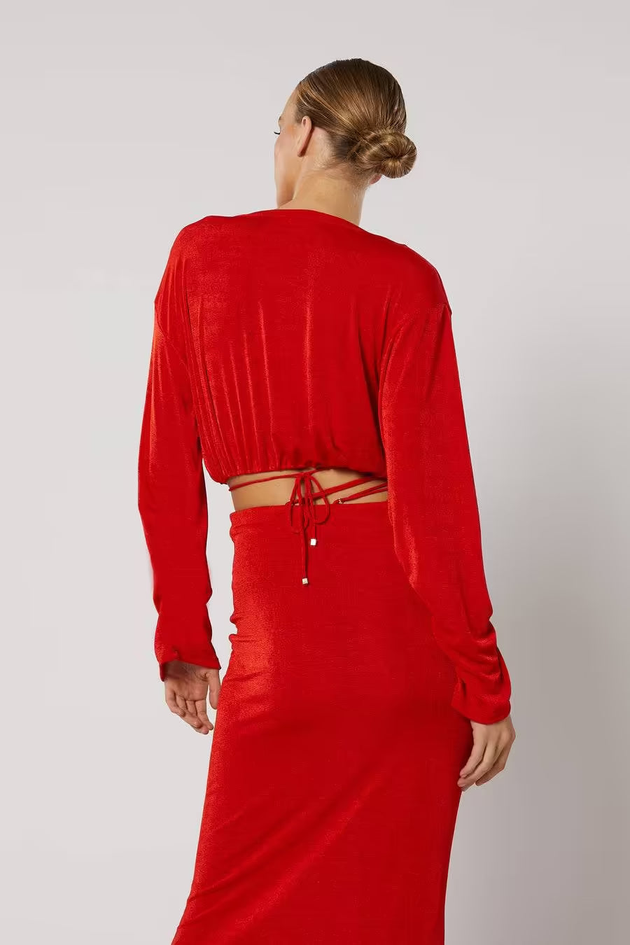 Red long-sleeve top, back view with tied waist and midriff cutout