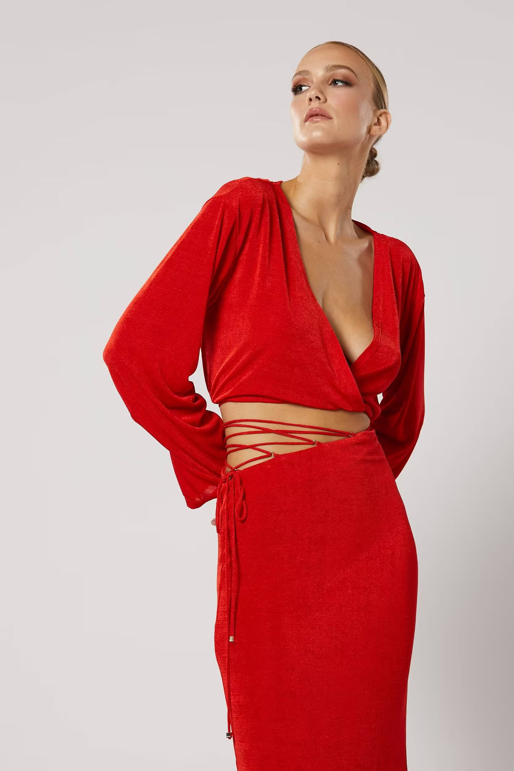 Red long-sleeve wrap top with V-neck and tied waist detail