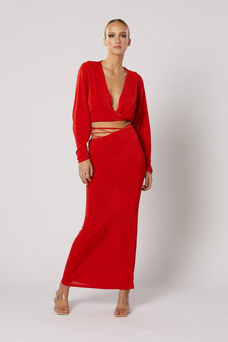 Red long-sleeve wrap top with V neckline and tied waist cutout