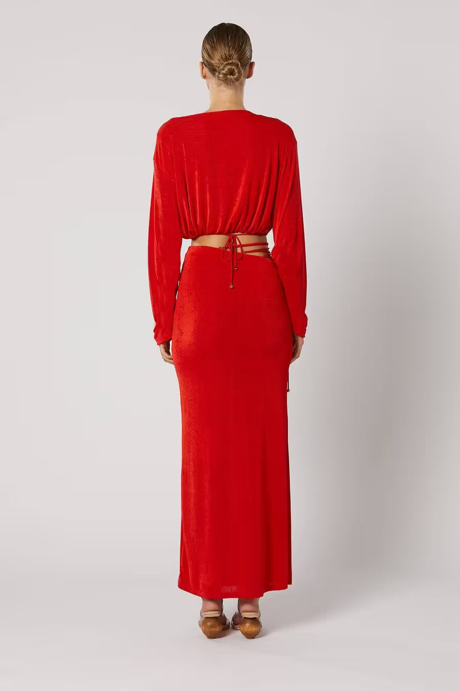 Red maxi skirt from the back showing full length and lace-up waistband