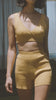 a woman in a yellow Bare by Charlie Holiday The Crop Top and shorts