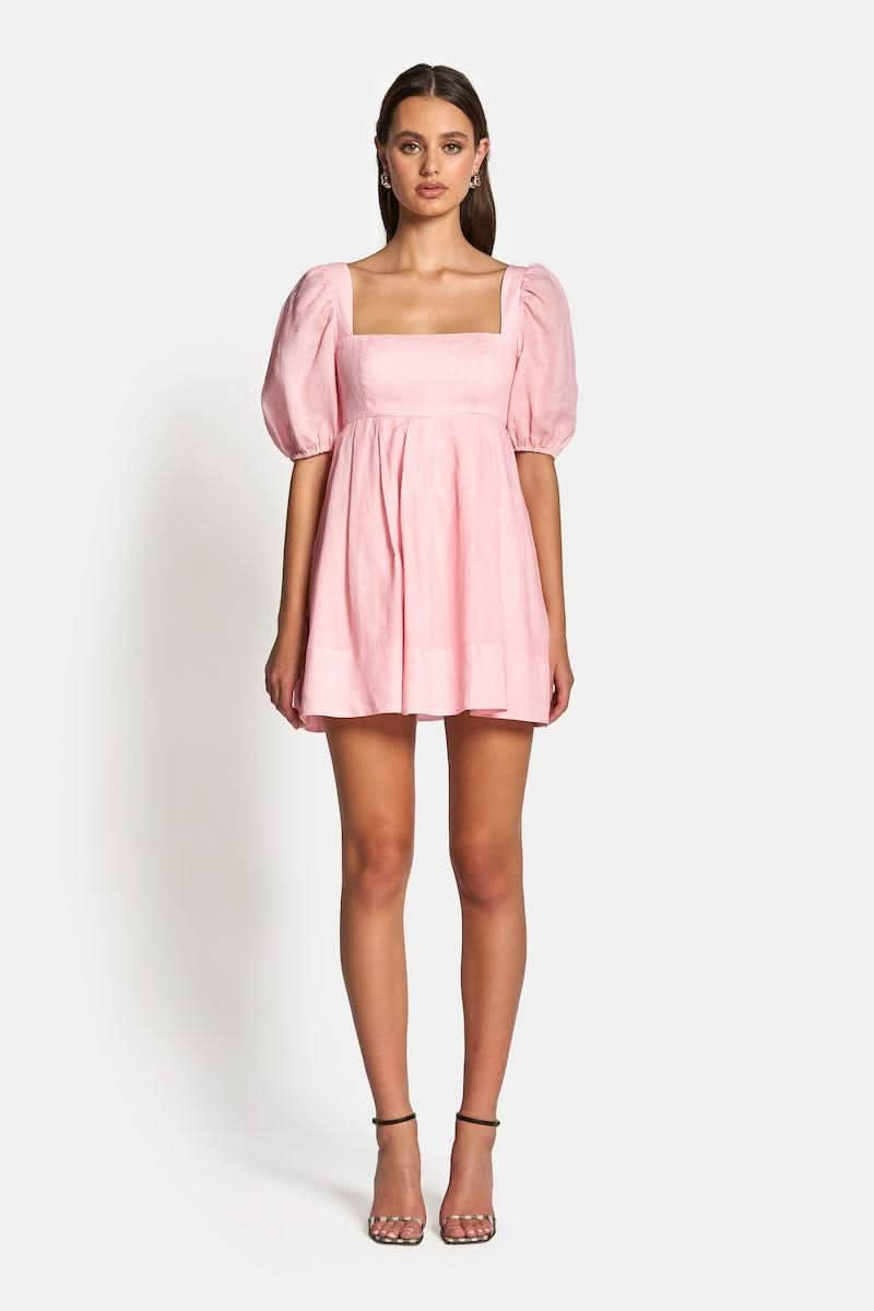 a model in a pink Sofia The Label Aerin Open Back Tie Mini Dress