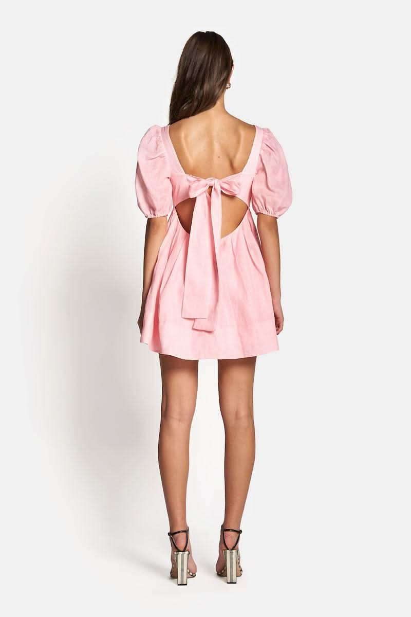 the back of a woman wearing a pink Sofia The Label Aerin Open Back Tie Mini Dress