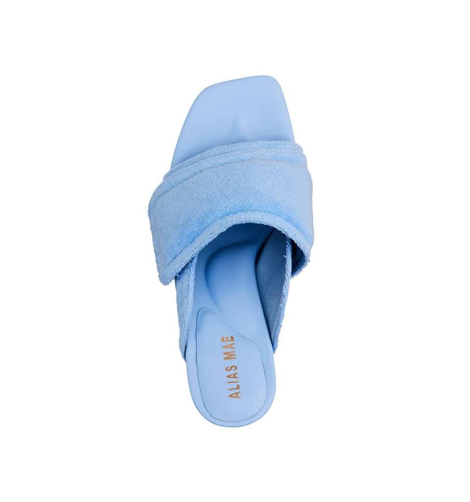 Pale blue terry slide mule sandal with open toe and wide wrapover strap