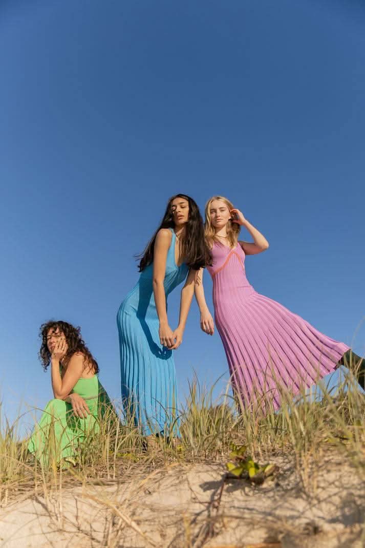 Purple ribbed maxi dress on model in group photo, crisscross neckline