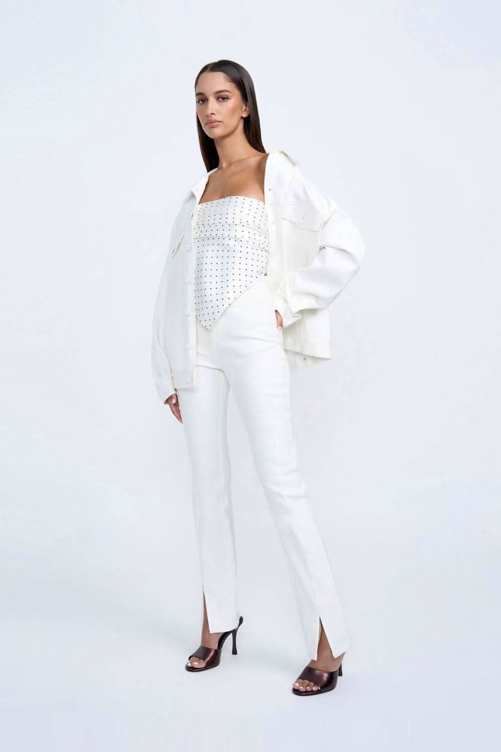 White denim-style jacket with button front and flap pockets, worn full view