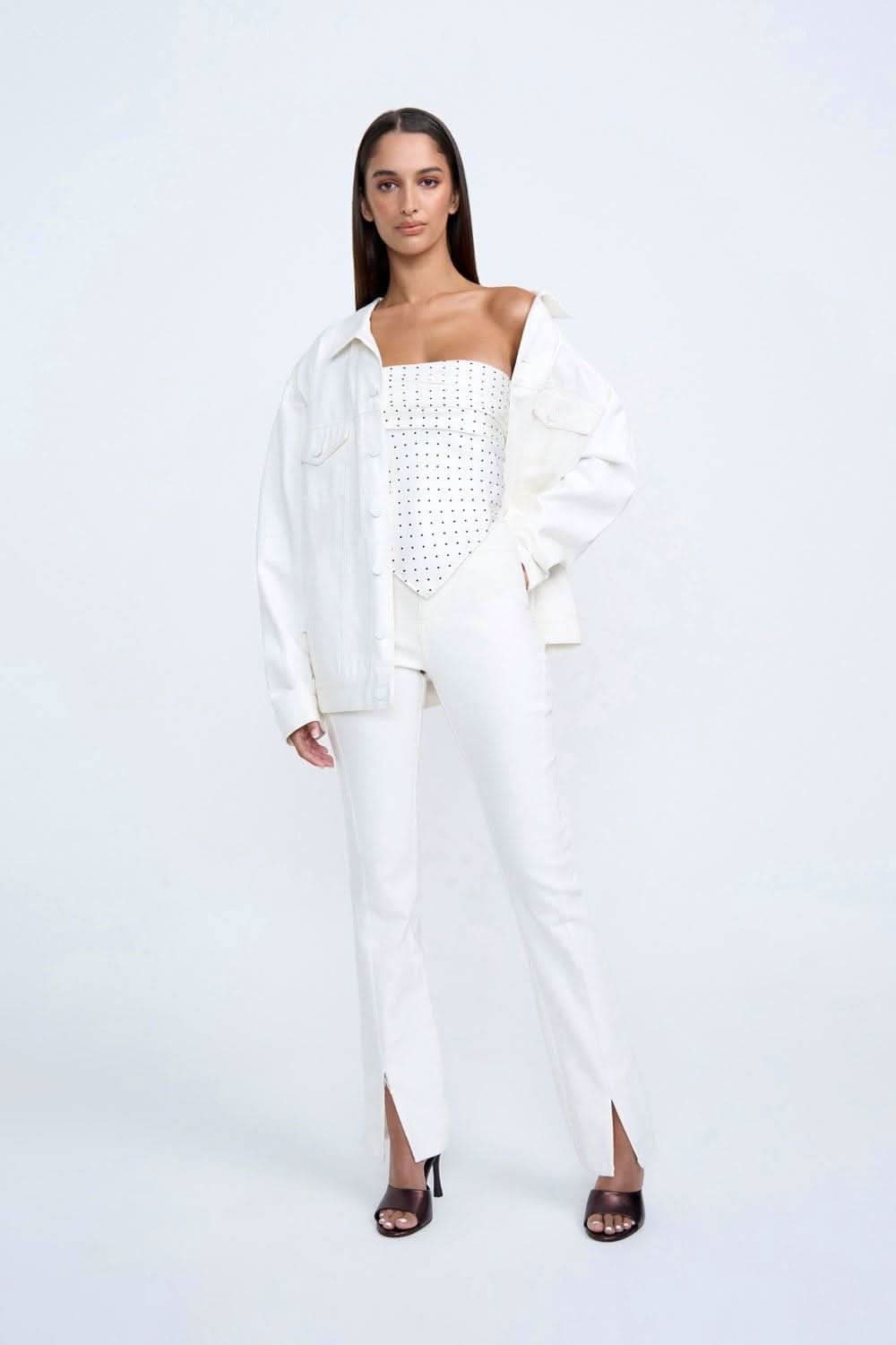 White denim-style jacket with button front, chest pockets, and long sleeves
