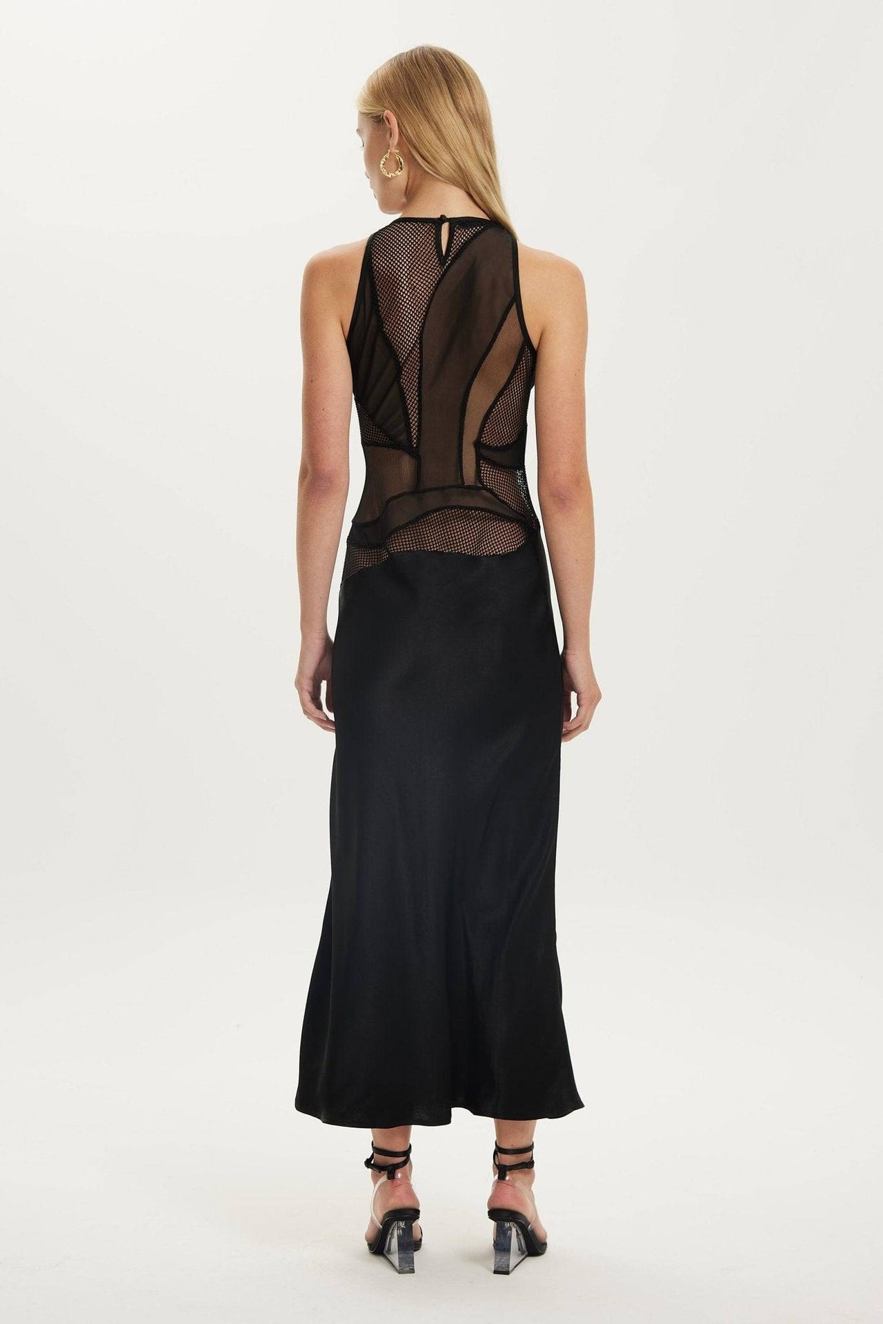 the back of a woman wearing a black Third Form Crystal Clear Maxi Tank Dress