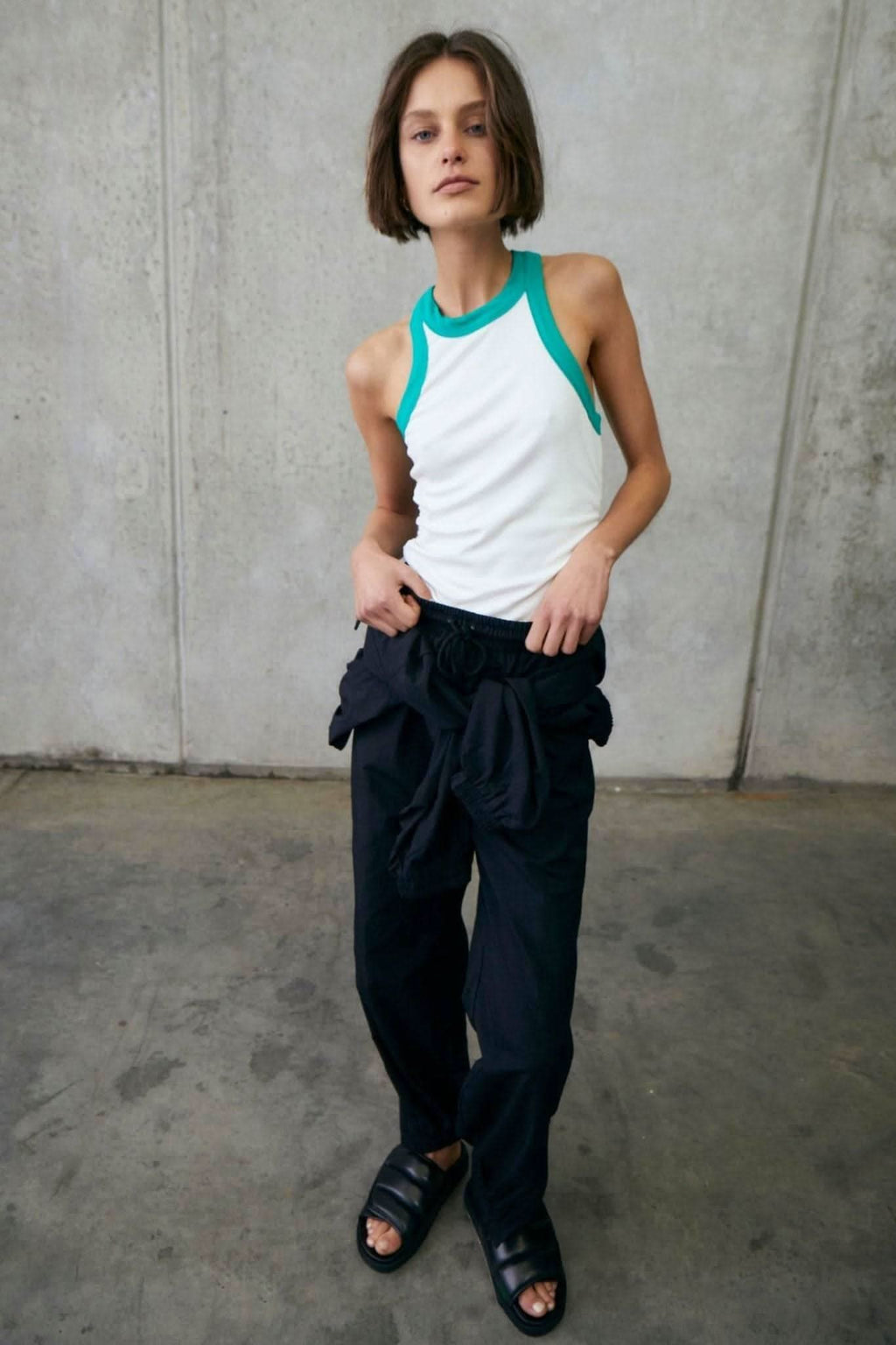 White sleeveless rib tank with alpine green trim at neck and armholes