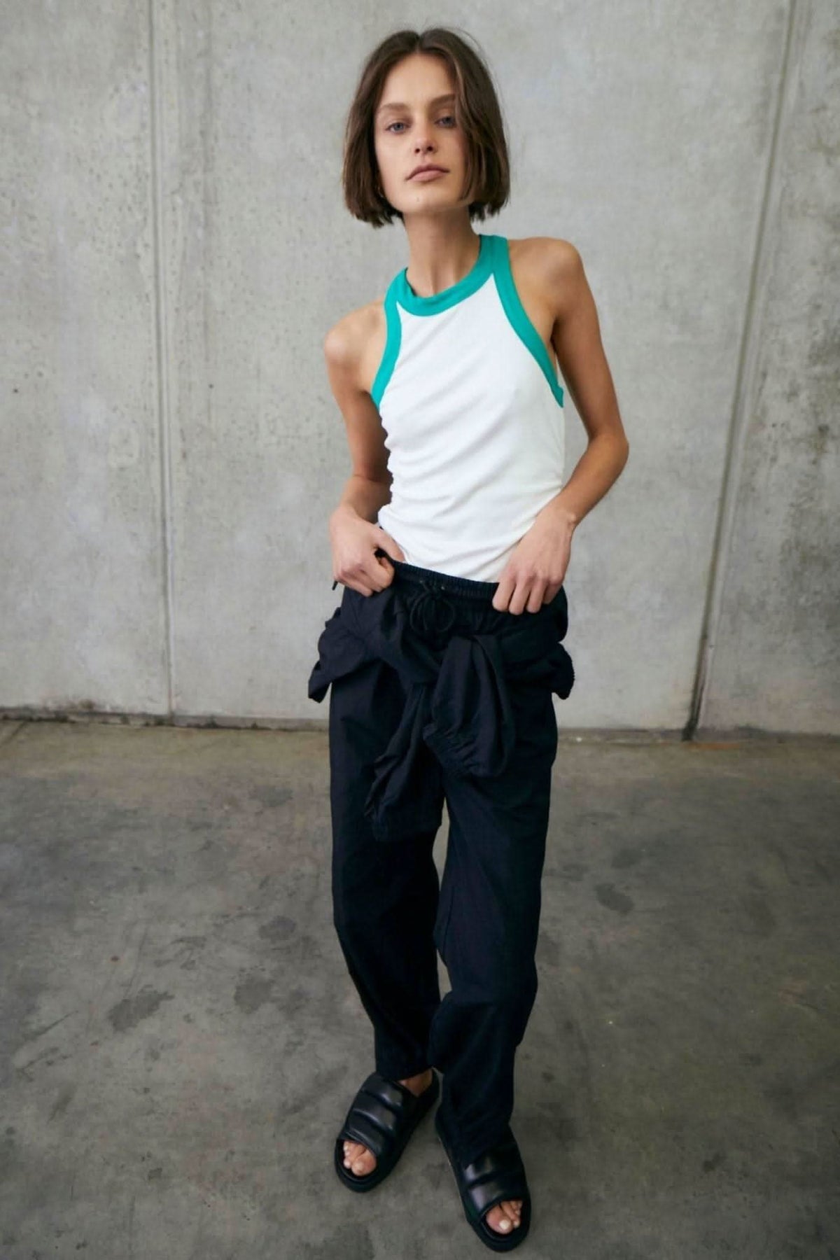 White sleeveless rib tank with alpine green trim at neck and armholes