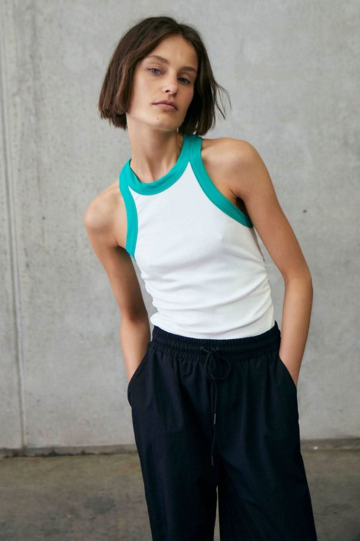 White rib tank with alpine green collar and armholes, sleeveless racerback