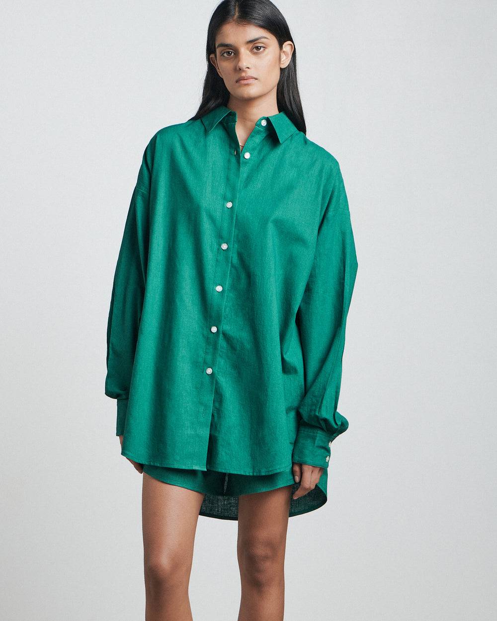 a woman wearing a green Bare by Charlie Holiday The Long Sleeve Shirt and shorts