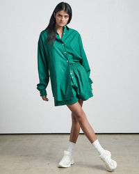 Thumbnail for a woman in a green Bare by Charlie Holiday The Long Sleeve Shirt and white tennis shoes