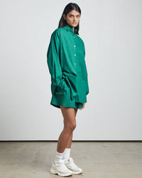 Thumbnail for a woman in a green Bare by Charlie Holiday The Long Sleeve Shirt and white tennis shoes